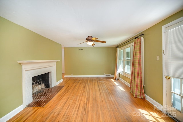 409 Edgewood Ct, Lancaster, SC 29720 - unfurnished living room featuring baseboards, light wood finished floors, ceiling fan, and a fireplace