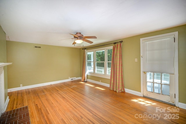 409 Edgewood Ct, Lancaster, SC 29720 - unfurnished living room with light wood-type flooring, ceiling fan, and baseboards