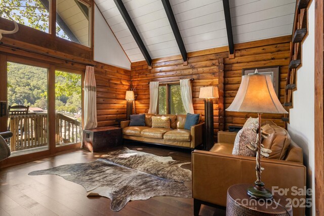2827 Memorial Hwy, Lake Lure, NC 28746 - living room with plenty of natural light, wood finished floors, log walls, high vaulted ceiling, and wooden ceiling with exposed beams