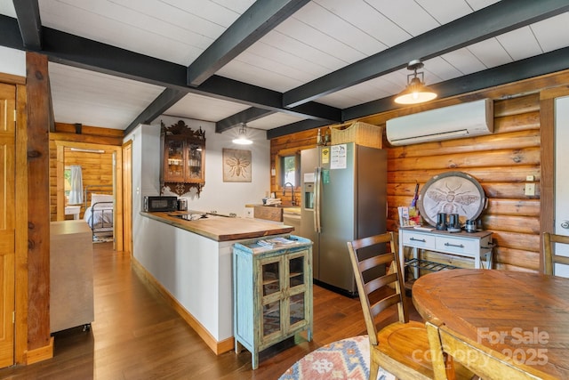 2827 Memorial Hwy, Lake Lure, NC 28746 - kitchen with butcher block counters, an AC wall unit, stainless steel refrigerator with ice dispenser, wood finished floors, and beam ceiling