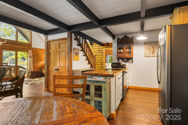 2827 Memorial Hwy, Lake Lure, NC 28746 - kitchen with stainless steel appliances, butcher block countertops, hardwood / wood-style floors, rustic walls, and beam ceiling
