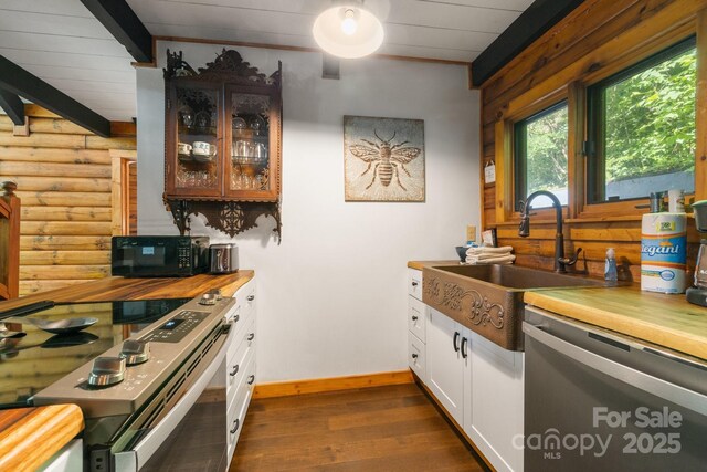2827 Memorial Hwy, Lake Lure, NC 28746 - kitchen with stainless steel appliances, rustic walls, dark wood-type flooring, a sink, and baseboards
