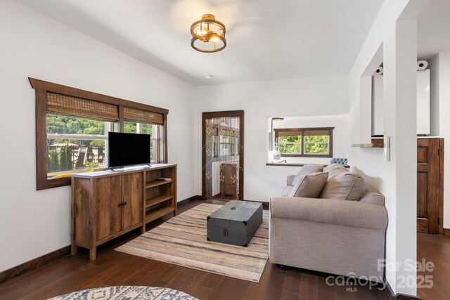 2827 Memorial Hwy, Lake Lure, NC 28746 - living room featuring dark wood-style flooring, baseboards, and a chandelier