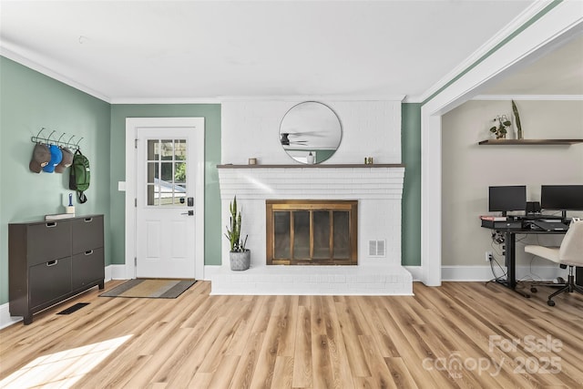 1072 5th St NE, Hickory, NC 28601 - living area with ornamental molding, light wood-style flooring, an office area, and a brick fireplace