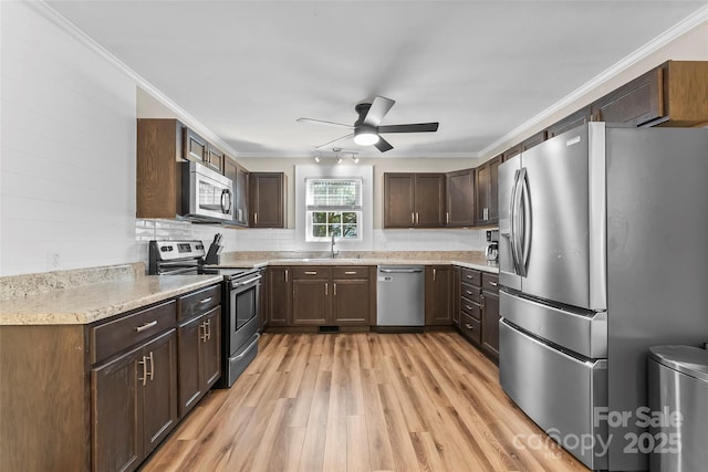 1072 5th St NE, Hickory, NC 28601 - kitchen featuring appliances with stainless steel finishes, ceiling fan, crown molding, light wood-type flooring, and light countertops