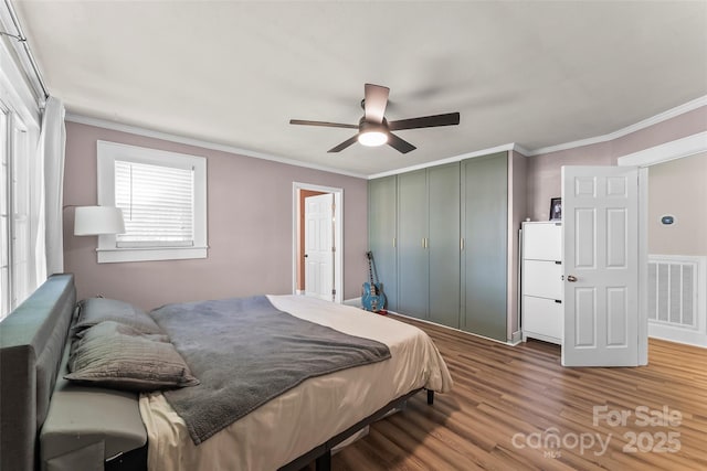 1072 5th St NE, Hickory, NC 28601 - bedroom with wood finished floors, ornamental molding, a closet, and a ceiling fan