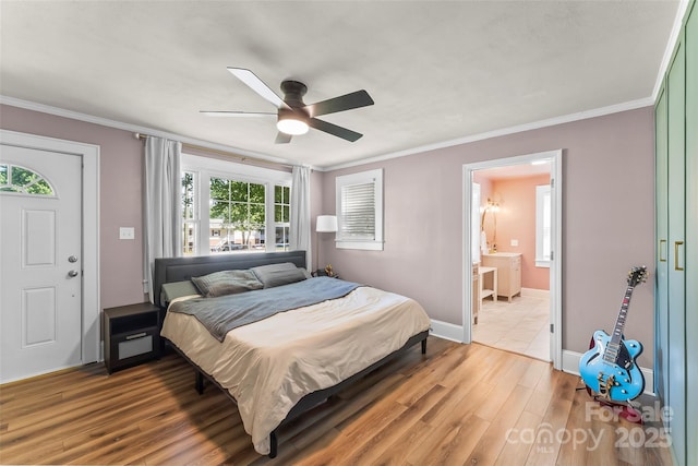 1072 5th St NE, Hickory, NC 28601 - bedroom with wood finished floors, crown molding, ensuite bathroom, and ceiling fan
