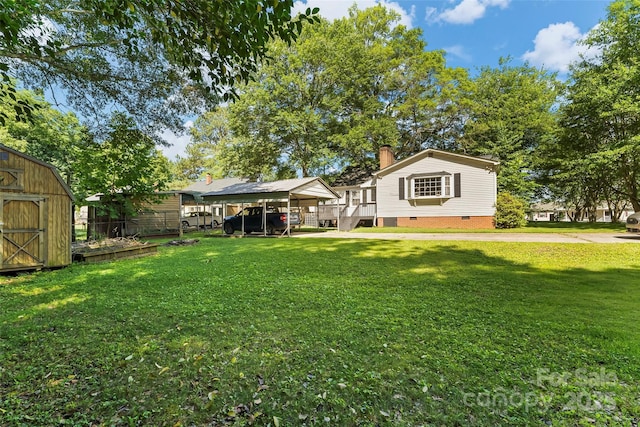 1072 5th St NE, Hickory, NC 28601 - rear view of house with crawl space, a shed, a chimney, a lawn, and a carport