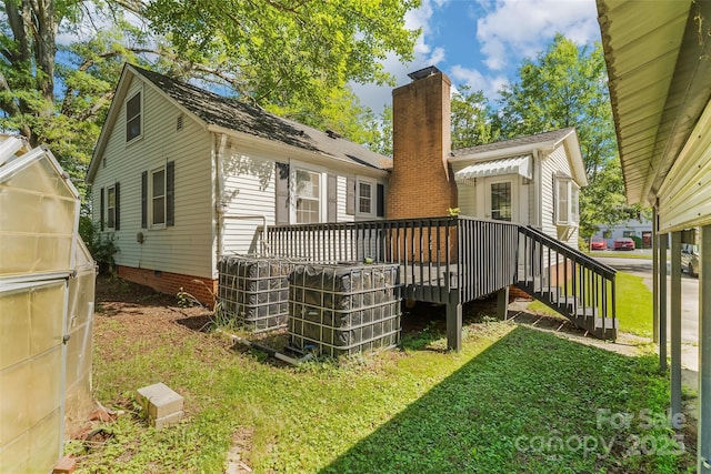 1072 5th St NE, Hickory, NC 28601 - rear view of house with a wooden deck, a lawn, and an exterior structure