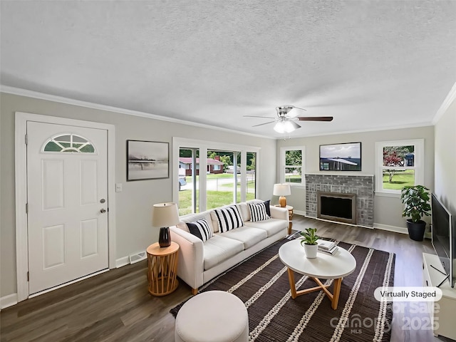 2136 W 6th Ave, Gastonia, NC 28052 - living area with plenty of natural light, wood finished floors, crown molding, a ceiling fan, and a fireplace