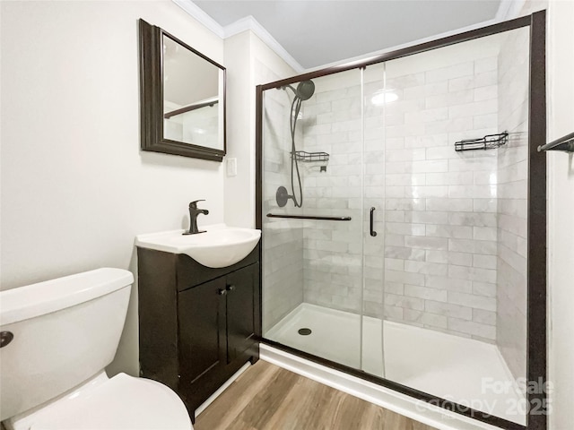 2136 W 6th Ave, Gastonia, NC 28052 - bathroom with toilet, vanity, a shower stall, wood finished floors, and ornamental molding