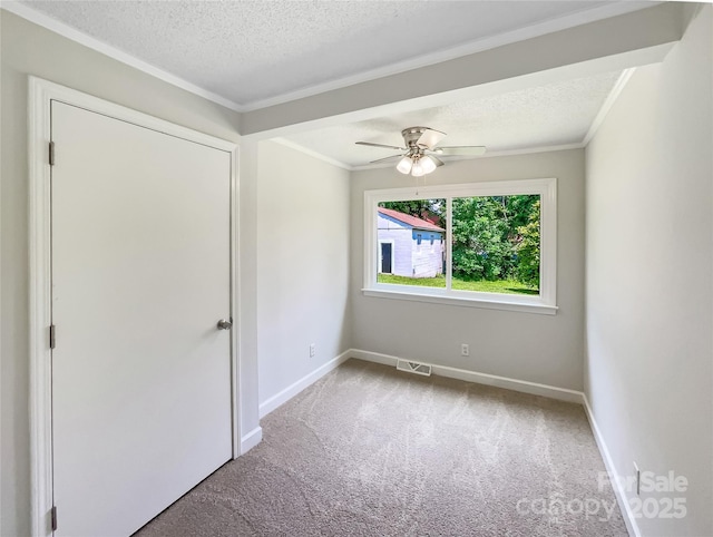 2136 W 6th Ave, Gastonia, NC 28052 - carpeted empty room with baseboards, a textured ceiling, a ceiling fan, and ornamental molding