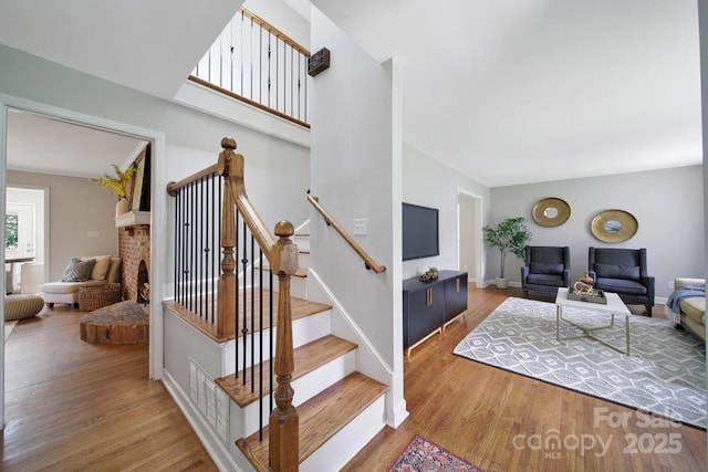 3800 Lovett Cir, Charlotte, NC 28210 - stairs featuring wood finished floors and a brick fireplace