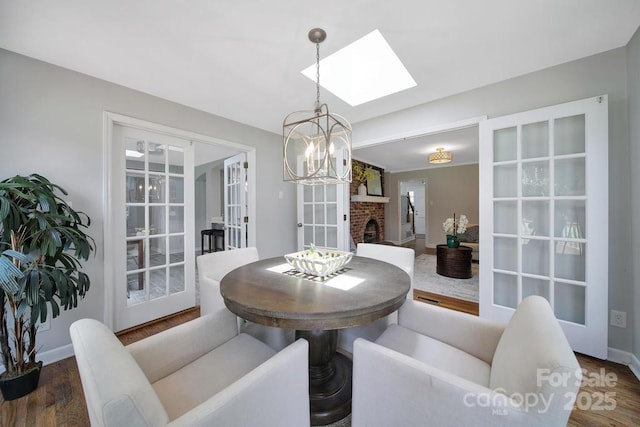 3800 Lovett Cir, Charlotte, NC 28210 - dining space featuring a skylight, a chandelier, wood finished floors, and french doors