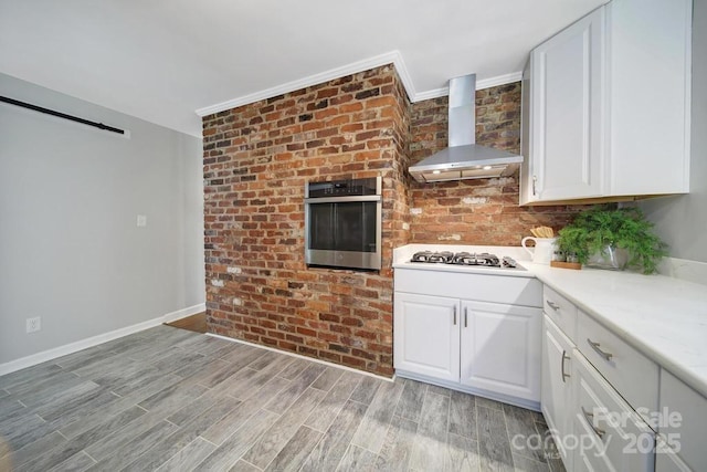 3800 Lovett Cir, Charlotte, NC 28210 - kitchen featuring wall chimney range hood, oven, gas stovetop, ornamental molding, and white cabinetry