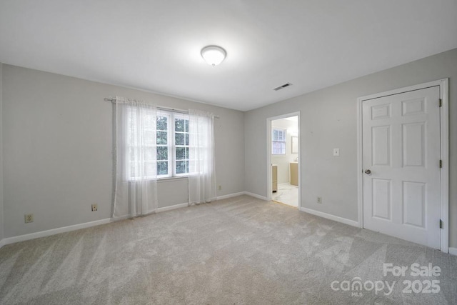 3800 Lovett Cir, Charlotte, NC 28210 - unfurnished bedroom featuring multiple windows, carpet, and connected bathroom