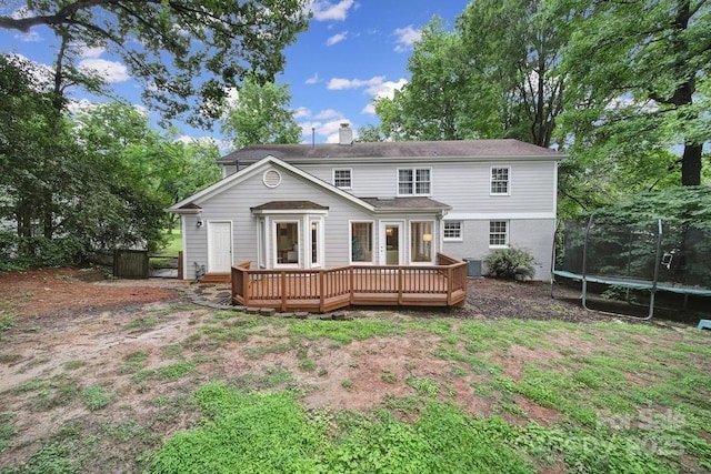 3800 Lovett Cir, Charlotte, NC 28210 - rear view of property with a trampoline, a wooden deck, and a chimney