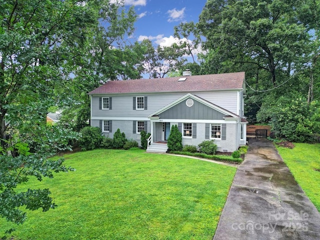 3800 Lovett Cir, Charlotte, NC 28210 - view of front facade with driveway, a chimney, a front yard, and a shingled roof