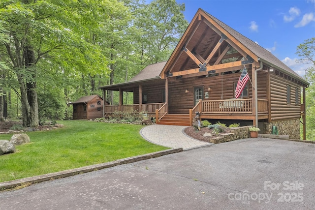 265 Laurel Mountain Estates Dr, Todd, NC 28684 - view of front of house with covered porch, a front lawn, and log veneer siding