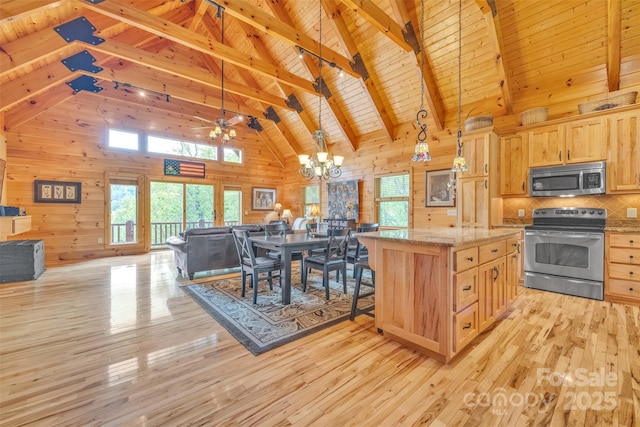265 Laurel Mountain Estates Dr, Todd, NC 28684 - kitchen featuring stainless steel appliances, open floor plan, wooden ceiling with exposed beams, wood walls, and light brown cabinetry