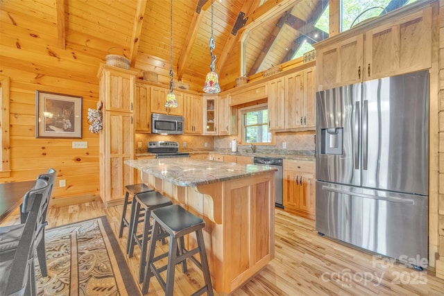 265 Laurel Mountain Estates Dr, Todd, NC 28684 - kitchen featuring stainless steel appliances, light wood finished floors, decorative backsplash, a center island, and light stone counters