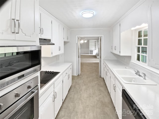 302 Melinda Ave, Kannapolis, NC 28083 - kitchen with appliances with stainless steel finishes, under cabinet range hood, light countertops, a sink, and white cabinets