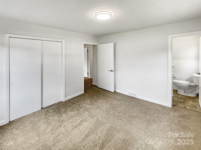 302 Melinda Ave, Kannapolis, NC 28083 - unfurnished bedroom with carpet, a closet, baseboards, and ensuite bathroom