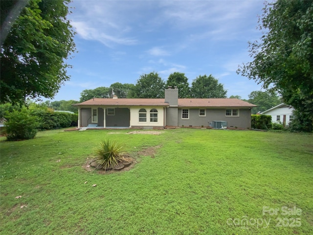 302 Melinda Ave, Kannapolis, NC 28083 - back of house featuring a chimney, a yard, and central AC