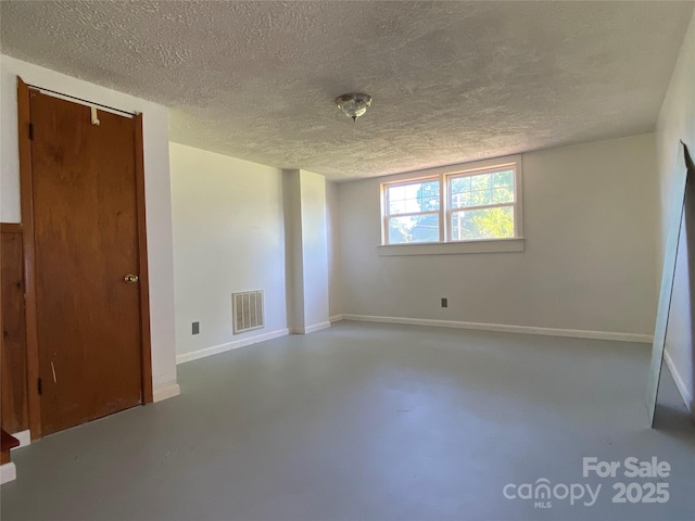 1300 Montgomery Ave, Albemarle, NC 28001 - unfurnished bedroom featuring finished concrete flooring and a textured ceiling