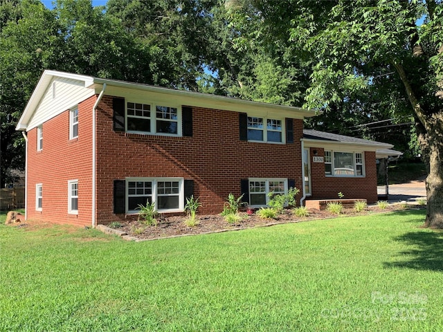 1300 Montgomery Ave, Albemarle, NC 28001 - tri-level home with a front yard and brick siding