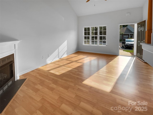 1573 Maypine Commons Way, Rock Hill, SC 29732 - unfurnished living room featuring a ceiling fan, a fireplace with flush hearth, wood finished floors, high vaulted ceiling, and baseboards