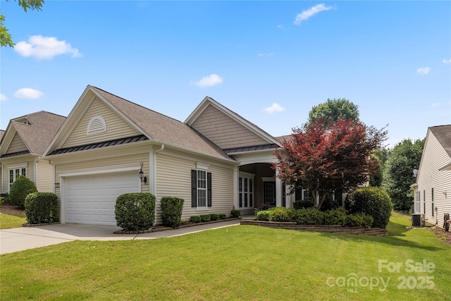 56119 Finches Ct, Indian Land, SC 29707 - view of front facade with a standing seam roof, concrete driveway, a front lawn, a metal roof, and an attached garage