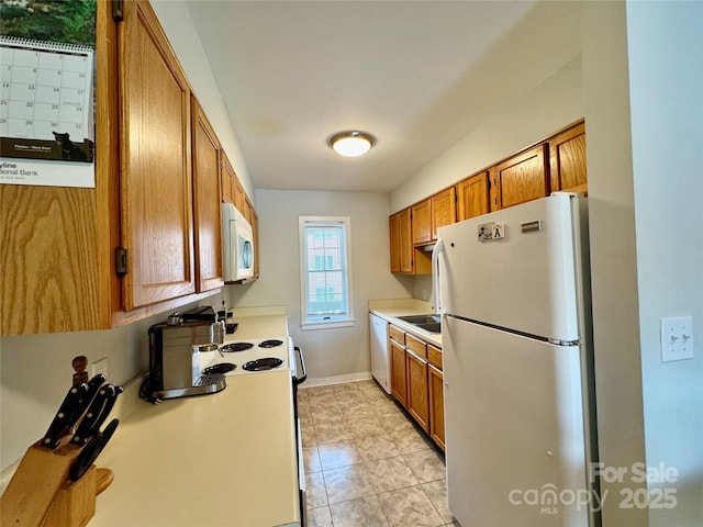 116 Grand Blvd Unit 4-B, Boone, NC 28607 - kitchen with white appliances, brown cabinetry, light countertops, a sink, and light tile patterned floors