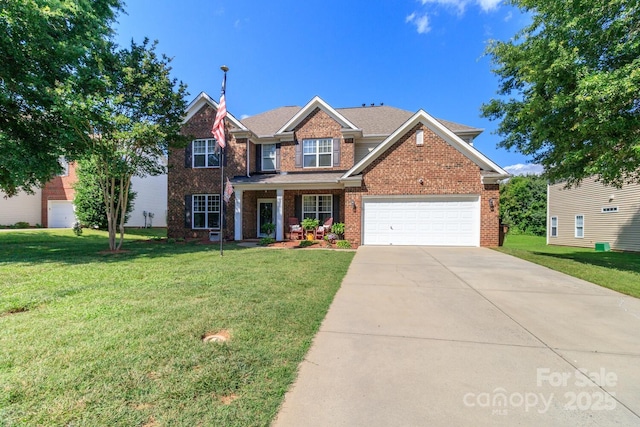 1006 Apogee Dr, Indian Trail, NC 28079 - view of front of home featuring a front yard, driveway, and brick siding