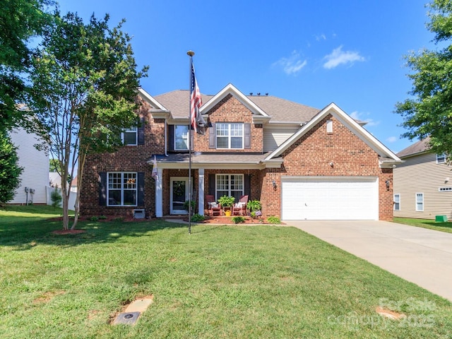 1006 Apogee Dr, Indian Trail, NC 28079 - view of front facade with a garage, a front yard, driveway, brick siding, and covered porch