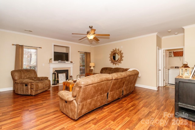 1006 Apogee Dr, Indian Trail, NC 28079 - living room with light wood-type flooring, crown molding, a ceiling fan, a fireplace with flush hearth, and washer / dryer