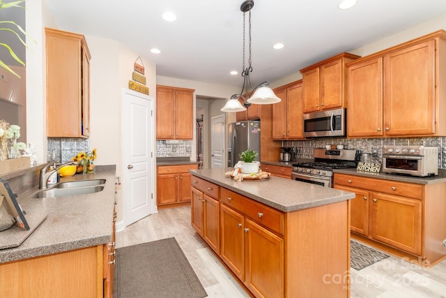 1006 Apogee Dr, Indian Trail, NC 28079 - kitchen featuring stainless steel appliances, a kitchen island, tasteful backsplash, light wood-style flooring, and recessed lighting