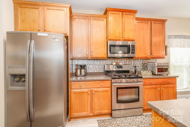 1006 Apogee Dr, Indian Trail, NC 28079 - kitchen with appliances with stainless steel finishes and tasteful backsplash