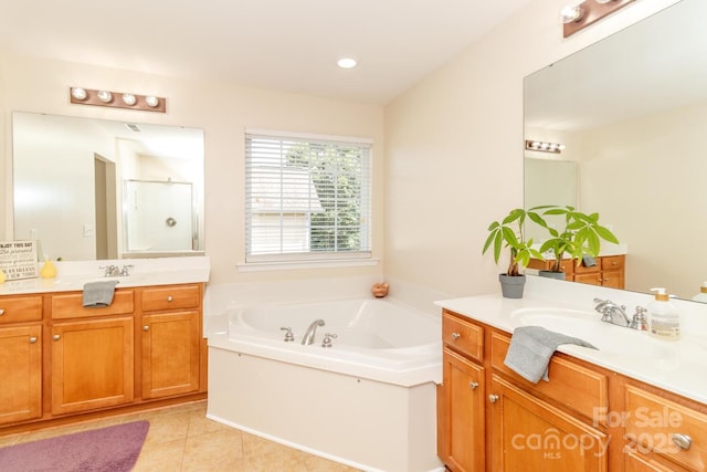 1006 Apogee Dr, Indian Trail, NC 28079 - full bath with a stall shower, two vanities, a bath, and tile patterned floors