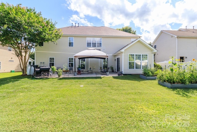 1006 Apogee Dr, Indian Trail, NC 28079 - back of house featuring a patio area, a garden, a gazebo, and a lawn