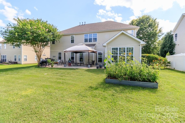 1006 Apogee Dr, Indian Trail, NC 28079 - back of property featuring a vegetable garden, a gazebo, and a patio area