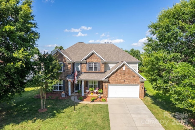 1006 Apogee Dr, Indian Trail, NC 28079 - traditional-style home with concrete driveway, a front lawn, brick siding, a garage, and a shingled roof
