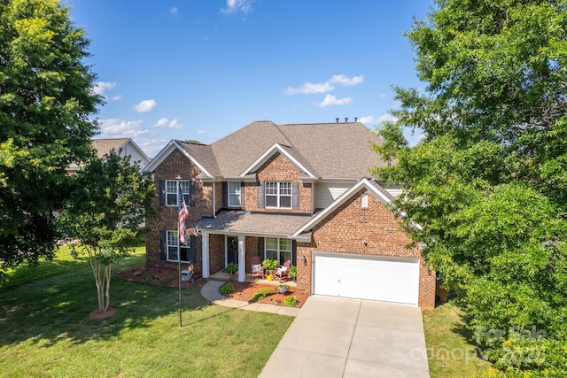 1006 Apogee Dr, Indian Trail, NC 28079 - view of front of house featuring brick siding, a front lawn, an attached garage, driveway, and a shingled roof