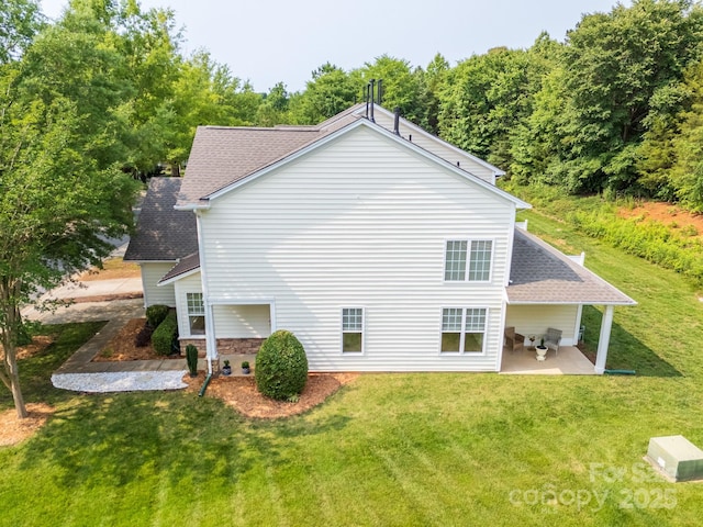 5963 Pale Moss Ln, Charlotte, NC 28269 - view of property exterior with a patio, a lawn, roof with shingles, and stone siding