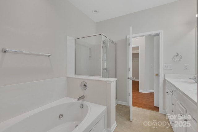 5963 Pale Moss Ln, Charlotte, NC 28269 - full bathroom featuring a shower stall, a whirlpool tub, double vanity, tile patterned flooring, and baseboards