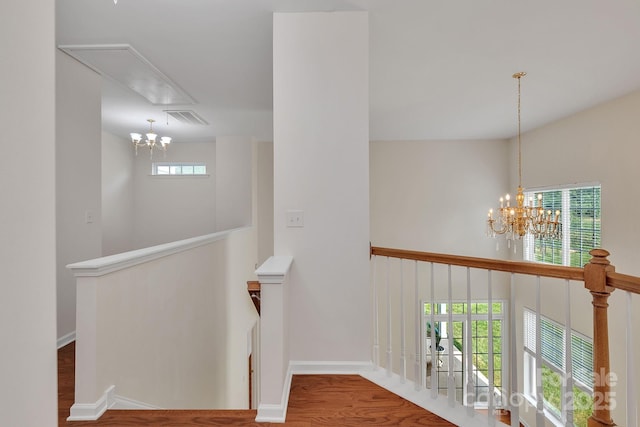 5963 Pale Moss Ln, Charlotte, NC 28269 - hallway with a chandelier, an upstairs landing, wood finished floors, and baseboards