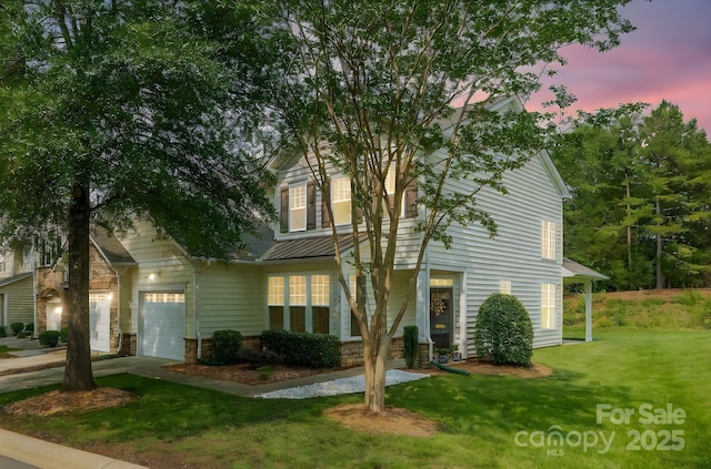 5963 Pale Moss Ln, Charlotte, NC 28269 - view of front of house featuring a standing seam roof, a lawn, metal roof, an attached garage, and driveway