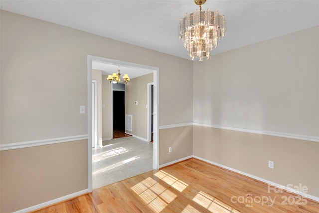2326 Horseshoe Bend Rd NE, Hickory, NC 28601 - spare room with a chandelier and wood finished floors