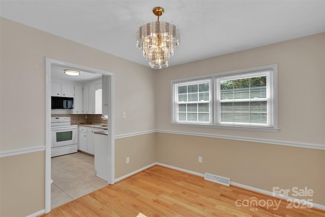 2326 Horseshoe Bend Rd NE, Hickory, NC 28601 - unfurnished dining area featuring a chandelier and light wood-style flooring
