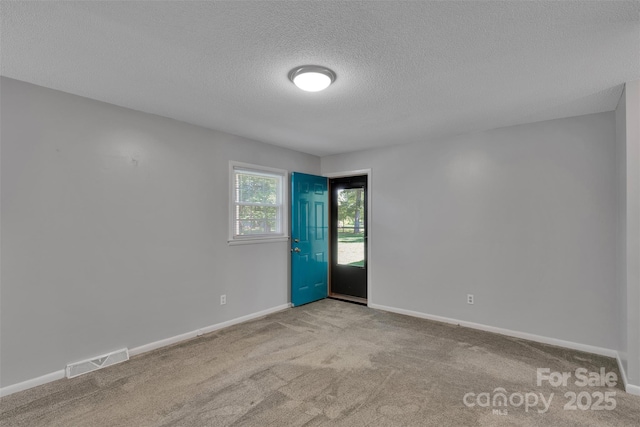 2326 Horseshoe Bend Rd NE, Hickory, NC 28601 - spare room with a textured ceiling and carpet flooring